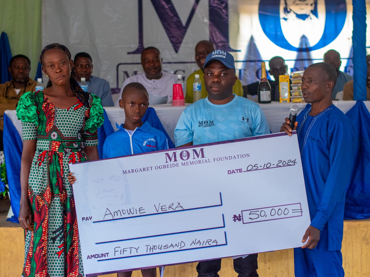 President General of ACU, Pastor Onyeibe presenting cheque to an Awardee